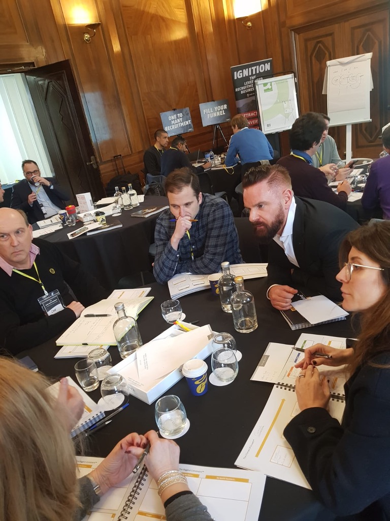 Firm owners working through the plan at their table during a live workshop